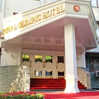 The main entrance and facade of the Royal Olympic Hotel in Kyiv with a red carpet