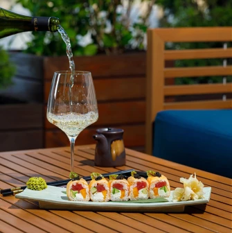 Serving sushi and white wine on the terrace of the "Veranda on the River" restaurant in Kyiv