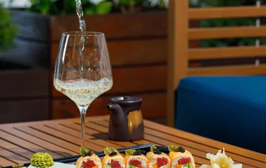 Serving sushi and white wine on the terrace of the "Veranda on the River" restaurant in Kyiv