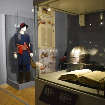 Cossack costume, helmet and ancient book at the National Museum of History of Ukraine in Kyiv
