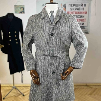Gray coat with a belt on a mannequin in the Levkovsky Vintage store-museum in Kyiv