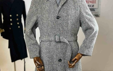 Gray coat with a belt on a mannequin in the Levkovsky Vintage store-museum in Kyiv