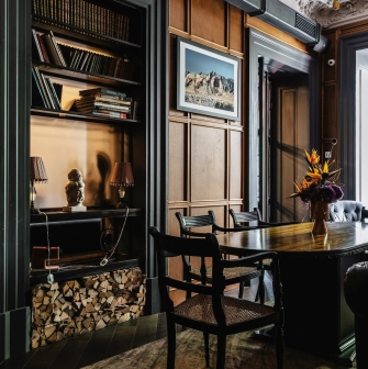 Restaurant Ulyublenyi Diadia - study room with wooden paneling, a desk, and built-in bookshelf