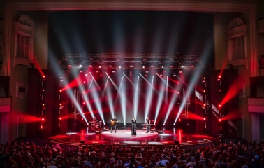 October Palace in Kyiv - concert stage illuminated by red spotlights beams