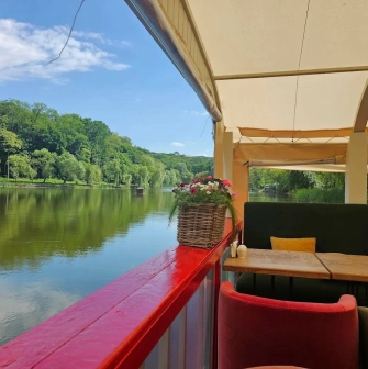 Restaurant Kukhnya Polli - lake view from an open terrace with decorative railings and flower pots
