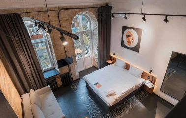 Room with a double bed and a brick wall at Globe Runner Hostel in Kyiv