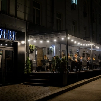 Zmist - cozy outdoor dining terrace with comfortable seating and lighting