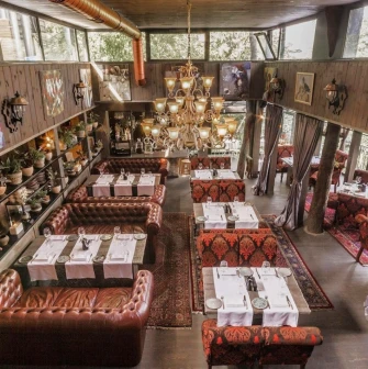Restaurant Kanapa - overhead view of a multi-level dining room with leather and patterned seating