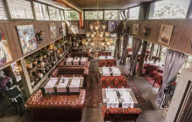 Restaurant Kanapa - overhead view of a multi-level dining room with leather and patterned seating
