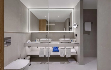 Radisson Blu - modern hotel bathroom with a bathtub and glass shower