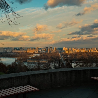 Park of Eternal Glory in Kyiv - sunset view of the Dnipro river and left bank from a stone terrace with benches