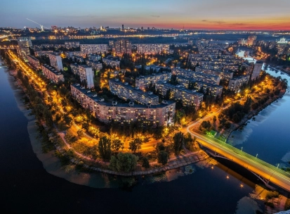 Rusanivska Naberezhna in Kyiv - aerial night view of the island district glowing with streetlights