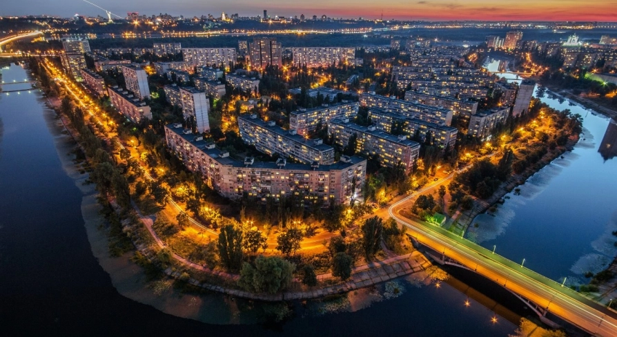 Rusanivska Naberezhna in Kyiv - aerial night view of the island district glowing with streetlights