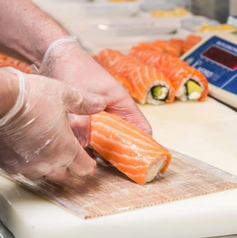 Egersund Seafood - chef preparing salmon rolls at the sushi counter