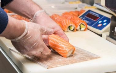 Egersund Seafood - chef preparing salmon rolls at the sushi counter