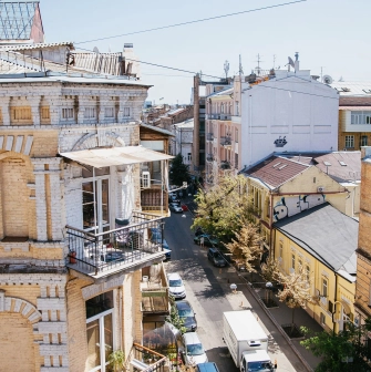 Vulytsia Reitarska in Kyiv - sunny view from a balcony overlooking a cozy street and old courtyards