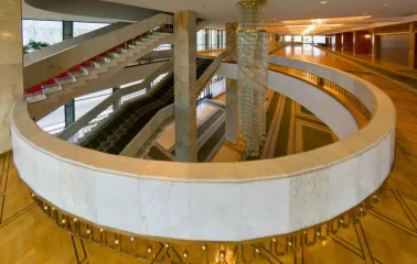 Palats Ukraina in Kyiv - elegant marble spiral staircase wrapping around a massive crystal chandelier in the foyer
