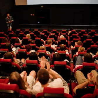 People on red seats during a movie screening in the Cinema Citi hall