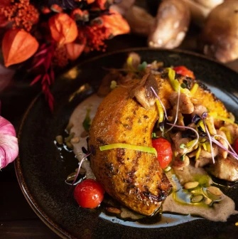 Khutorets na Dnipri – baked pumpkin with mushrooms, cherry tomatoes and creamy sauce, styled with autumn decor