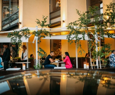 BEEF meat & wine - cozy outdoor terrace with tables and chairs near the railing