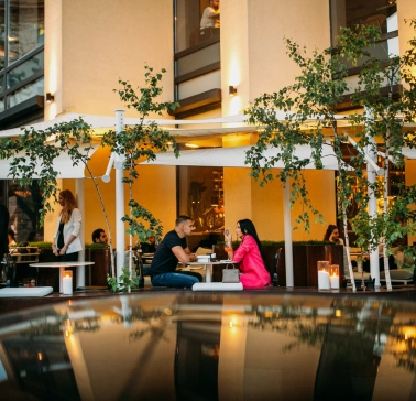 BEEF meat & wine - cozy outdoor terrace with tables and chairs near the railing