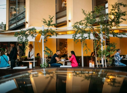 BEEF meat & wine - cozy outdoor terrace with tables and chairs near the railing