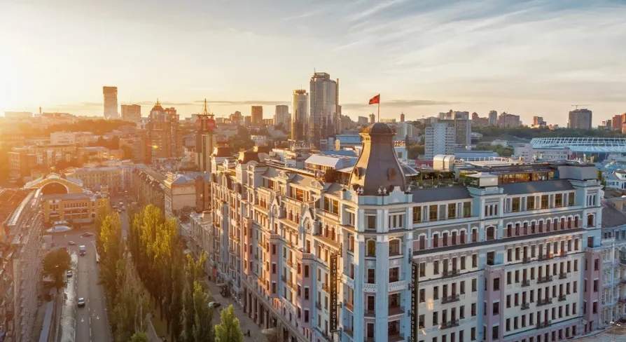 The facade of the Premier Palace Hotel in Kyiv with the Ukrainian flag on the roof