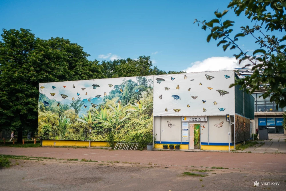 Exterior of the Planet of Butterflies farm with jungle-themed wall art