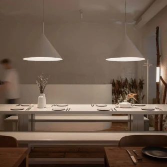 Restaurant 100 Rokiv Tomu Vpered - minimalist dining area with a long white communal table