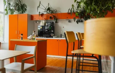 Kooperativ - minimalist communal kitchen area with stainless steel appliances