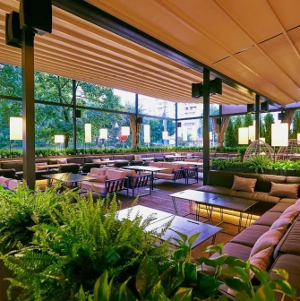 Par Bar - indoor terrace with sofas and plants under canopy