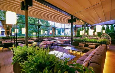 Par Bar - indoor terrace with sofas and plants under canopy