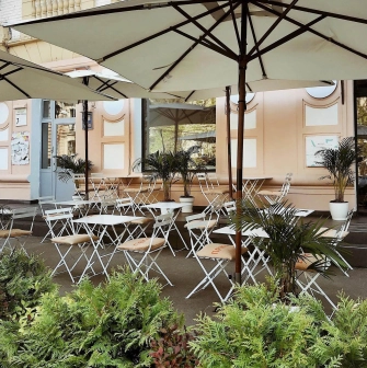 Restaurant Kytaiskyi Pryvit - empty summer terrace with tables chairs and large sun umbrellas