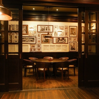 Goodman Steak House - spacious, elegant dining room with warm lighting and comfortable seating