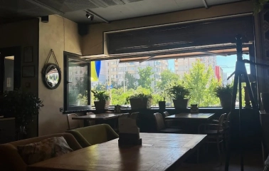 Chachapuri in Kyiv - dining hall interior with large open window and plants