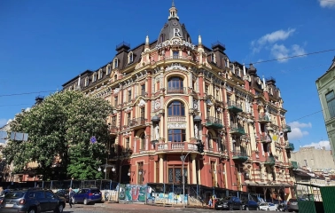 Volodymyrska Street in Kyiv - elaborate corner building with a dome and rich red and yellow facade decorations