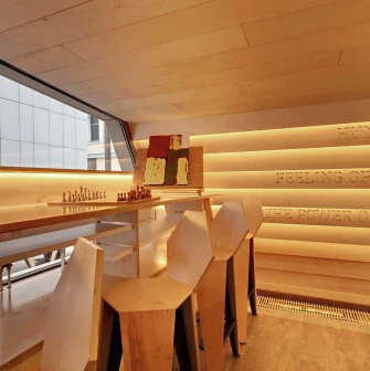 One Love Coffee in Kyiv - wooden interior corner with chess board by panoramic window