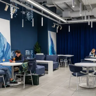 Egersund - brightly lit dining hall with spacious tables and overhead lamps
