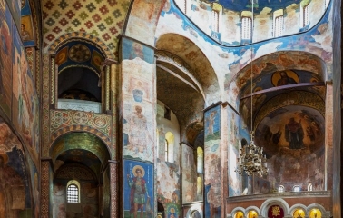 St. Cyril's Church in Kyiv- spacious nave with painted dome, chandelier and red floor