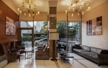 City Hotel in Kyiv - lobby lounge with chandeliers, sofas and large windows to street